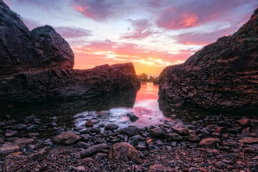 Sunrise at Nuns Baths from the stony beach.  Nestled in a rocky cove, it is one of the oldest ocean baths on the NSW coast