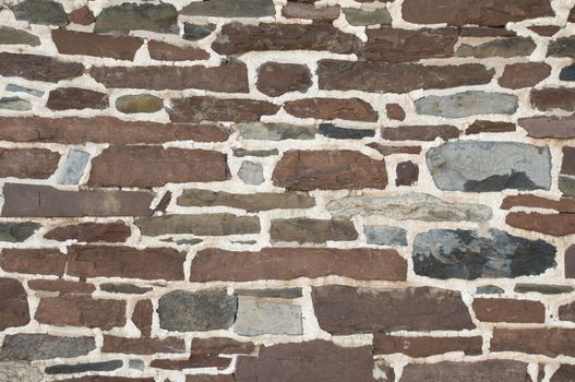 Weathered stone masonry wall background texture