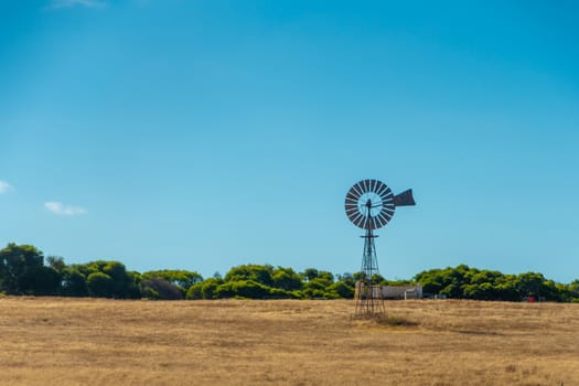 Old rusty windmill on dry farmland in Western Australia