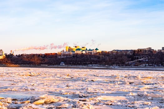 View of the city of Khabarovsk from the middle of the frozen Amur river. Factories on the horizon.