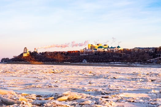 View of the city of Khabarovsk from the middle of the frozen Amur river. Factories on the horizon.