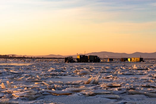 View of the city of Khabarovsk from the middle of the frozen Amur river. Factories on the horizon.