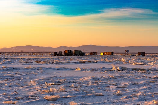 View of the city of Khabarovsk from the middle of the frozen Amur river. Factories on the horizon.