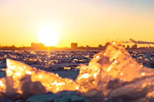 View of the city of Khabarovsk from the middle of the frozen Amur river. Factories on the horizon.