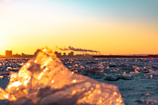 View of the city of Khabarovsk from the middle of the frozen Amur river. Factories on the horizon.