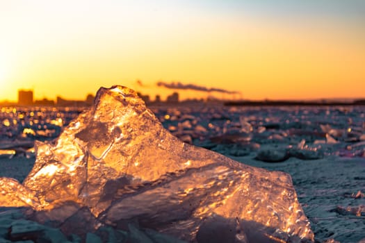 View of the city of Khabarovsk from the middle of the frozen Amur river. Factories on the horizon.