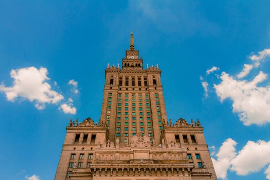 The Palace of Culture and Science of Warsaw from a low angle view. An historical public cultural institution and the tallest building in Poland.