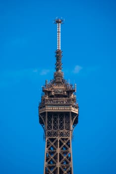 Spire peak of Eiffel Tower Tour Eiffel blue sky steel structure