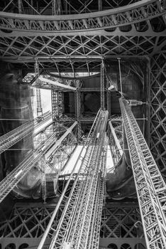 Standing under Eiffel Tower Tour Eiffel blue sky clouds black and white