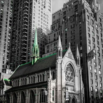 Church in New York Manhattan caught by the modern skyscrapers black white green
