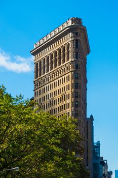 Flat Iron building New York Manhattan in sun blue sky