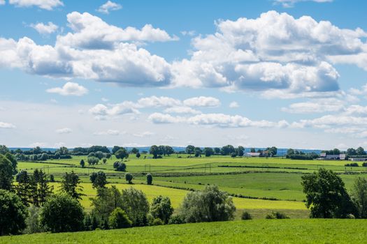 Green landscape, look over meadows blue sunny sky