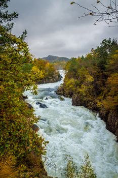 Waterfall rapid stream in fall Skandinavia