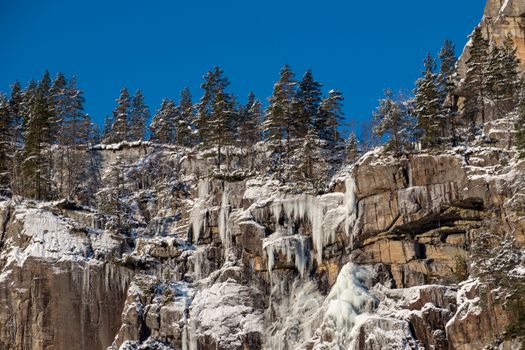 Icicle rock formation canyon trees sunny