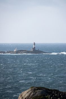 Lighthouse in winter storm ocean