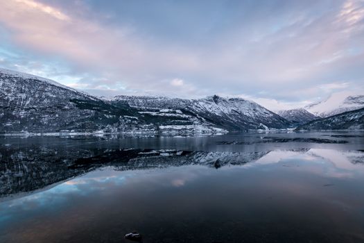 Mirror like reflection in lake mountains winter