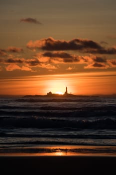 Sunset Hellstø beach with lighthouse yellow red Norway 3