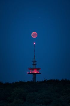 Blood moon red shining right above broadcasting tower germany