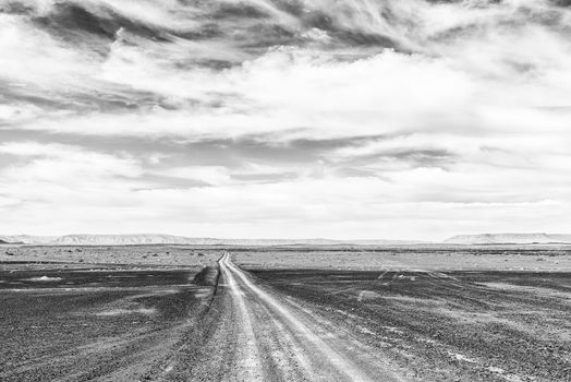 A road in a drought stricken part of the Tankwa Karoo in the Northern Cape Province of South Africa. Monochrome