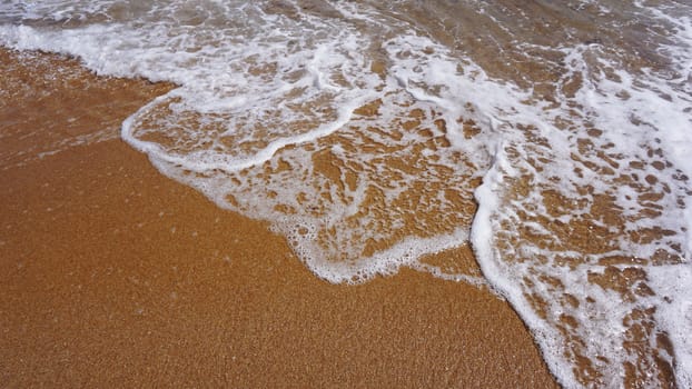 Soft wave of ocean on sandy beach, copy space, background. Ocean water nature, beach relax. Summer sea vacation