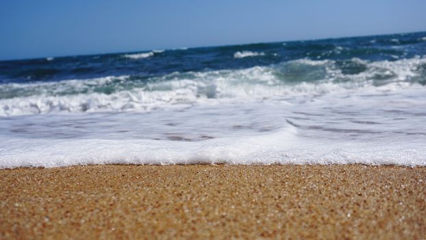 Tropical beach. Ocean wave background. Sand and blue sea. Ocean water nature, beach relax. Summer sea vacation