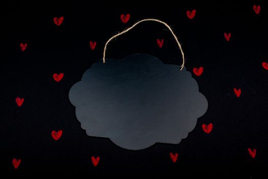 Black notice board  and red hearts on black background