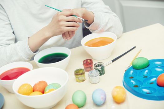 Woman preparing and dying Easter eggs