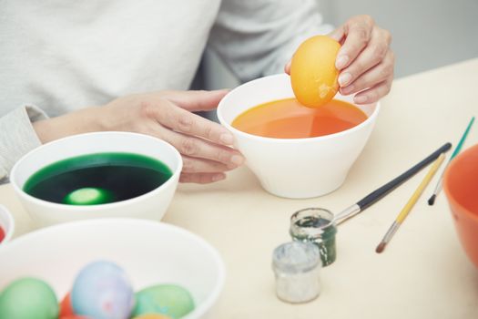 Woman preparing and dying Easter eggs