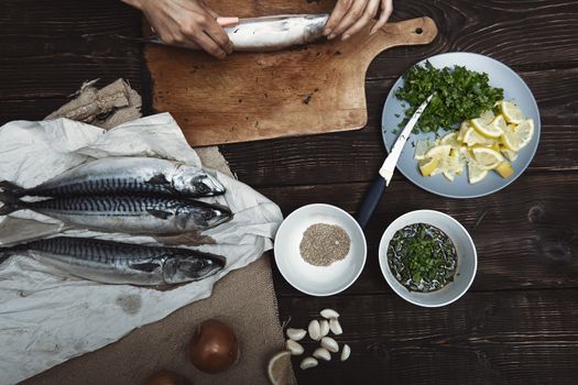 Woman preparing mackerel fish