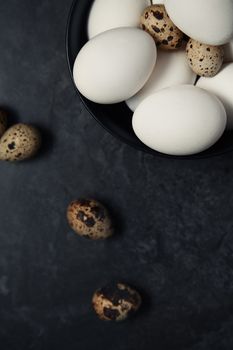 Quail and chicken eggs on a table