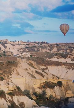 Hot air balloon flying over the rocks of Cappadocia, Turkey