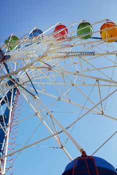 Ferris wheel in public amusement park. Low angle view