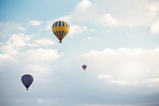 Three hot air balloons flying in the sky