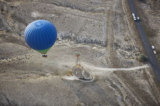 Blur hot air balloon flying over the road with motor transport. View from above