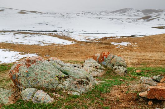 Steppe with colorful stones at the winter mountains