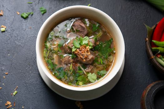 Asian bone soup or sup tulang, popular traditional malay dish. Top view flat lay.