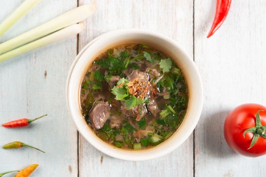 Asian bone soup or sup tulang, popular traditional malay dish. Top view flat lay.