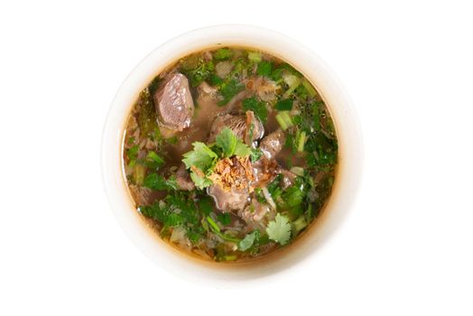 Asian bone soup or sup tulang, popular traditional malay dish. Top view flat lay isolated on white background .