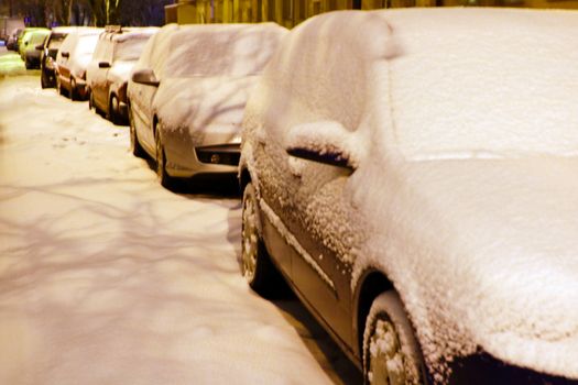 Winter city, drifts on the roads, cars in the snow and snow drifts