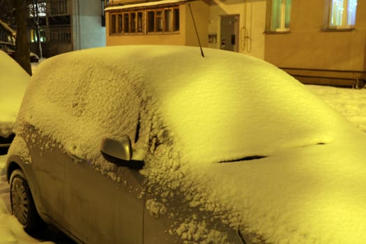 Winter city, drifts on the roads, cars in the snow and snow drifts