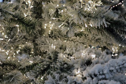 Christmas toys on the Christmas trees in New Year's Eve. New Year and Christmass green decoration lights, illumination. Garland with green lights