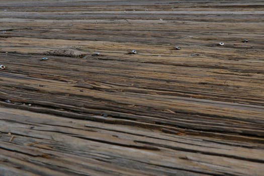 Top view of white planks wood pathway over sea at the port. Close up vintage flooring timber