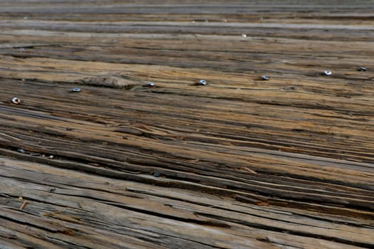 Top view of the wooden floor above the sea in the port. Close up vintage timber flooring