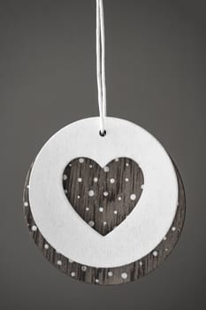Love heart hanging on wooden texture background, valentines day card concept