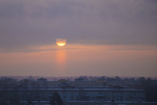 The sun rises on a frosty misty morning over the city