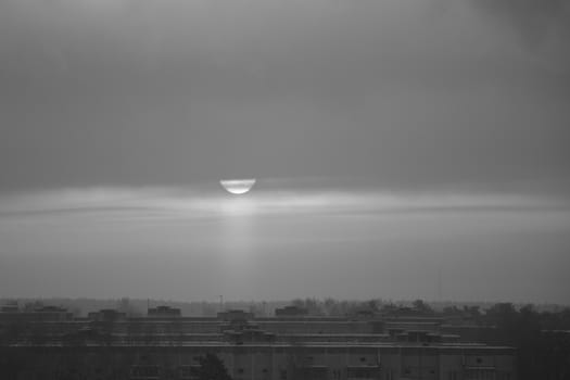 sunset in the clouds on a frosty winter day in the city