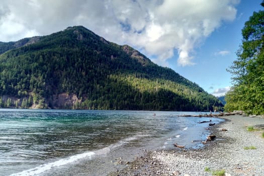 Beautiful view of the lake, surrounded by mountains, and the sky