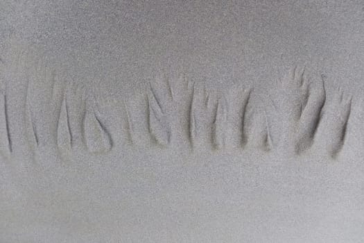 Minimalist beach scene of footprints in the sand. Background