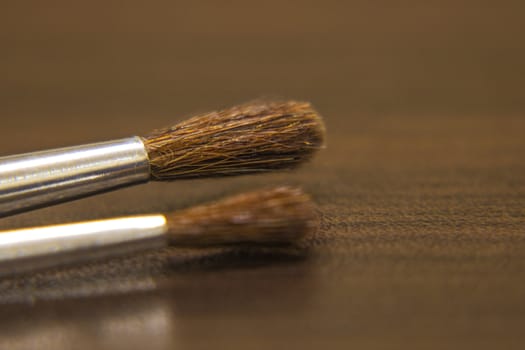 A set of brushes on the table side view