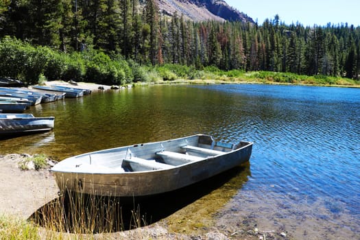 fishing boat docked in a calm lake of dreamy scenery.